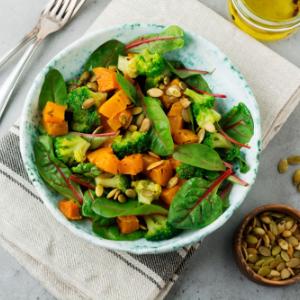 Broccoli salad with pumpkin seeds, almonds and roasted sweet potato